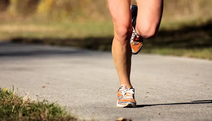 person running with orange shoes